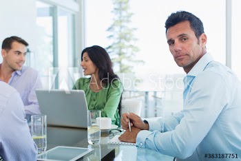 Portrait confident businessman in meeting