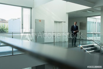 Portrait confident businessman in office corridor