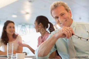 Portrait confident businessman in office meeting