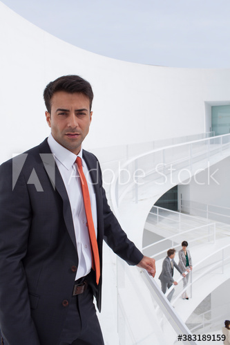 Portrait confident businessman on modern balcony