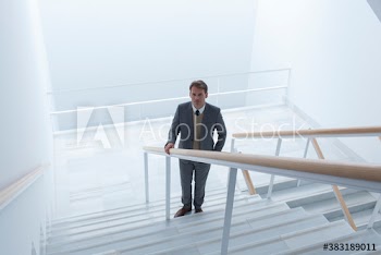 Portrait confident businessman on modern stairs