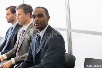 Portrait confident businessman waiting in office lobby
