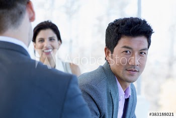 Portrait confident businessman with colleagues