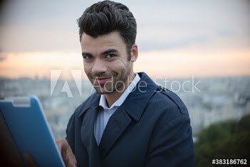 Portrait confident businessman with digital tablet