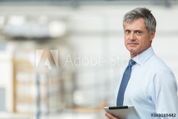 Portrait confident businessman with digital tablet