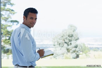 Portrait confident businessman with notebook on patio