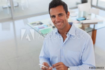 Portrait confident businessman with smart phone