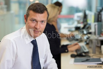 Portrait confident businessman working in office
