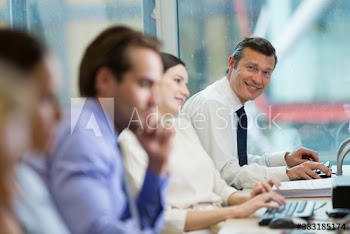 Portrait confident businessman working in open plan office