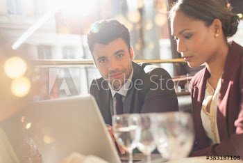 Portrait confident businessman working with colleague in restaurant