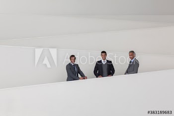 Portrait confident businessmen on modern office ramp