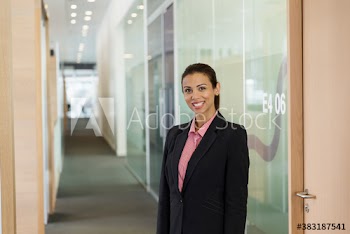Portrait confident businesswoman in office corridor