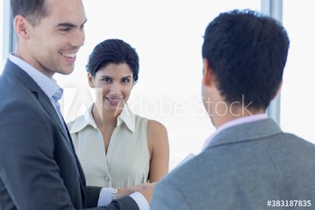 Portrait confident businesswoman talking with colleagues