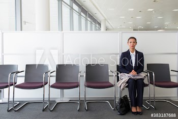 Portrait confident businesswoman waiting for job interview in lobby