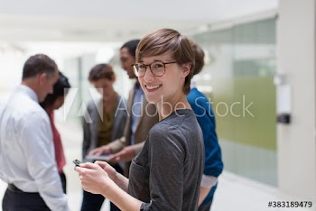 Portrait confident businesswoman with colleagues in office