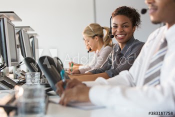 Portrait confident businesswoman with headset working in call center