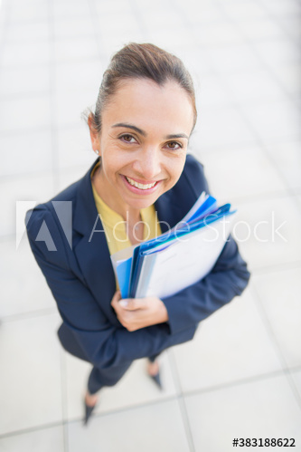 Portrait confident businesswoman with paperwork