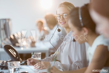 Portrait confident businesswoman working at call center