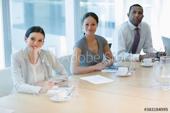 Portrait confident corporate business people in conference room meeting