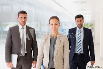 Portrait confident corporate business people in corridor