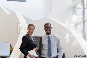 Portrait confident corporate business people on modern office stairs