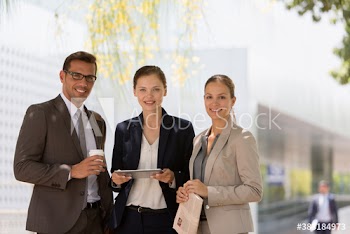 Portrait confident corporate business people with digital tablet