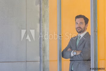 Portrait confident corporate businessman at office window