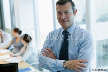 Portrait confident corporate businessman in conference room