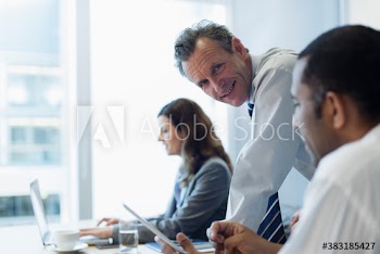 Portrait confident corporate businessman in conference room meeting