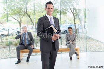 Portrait confident corporate businessman in modern lobby