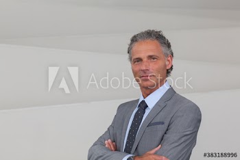 Portrait confident corporate businessman in suit