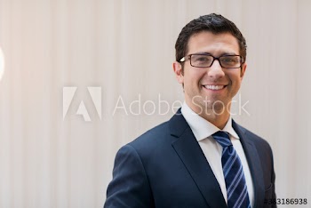 Portrait confident corporate businessman in suit and eyeglasses