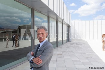 Portrait confident corporate businessman on modern office patio