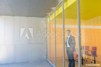 Portrait confident corporate businessman standing at office window