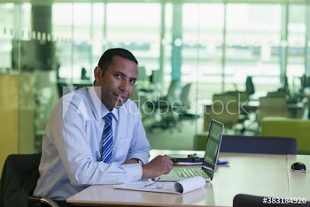 Portrait confident corporate businessman working in conference room