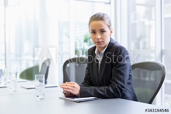 Portrait confident corporate businesswoman in conference room