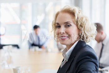 Portrait confident corporate businesswoman in meeting