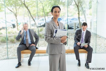 Portrait confident corporate businesswoman in modern lobby
