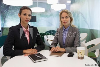 Portrait confident corporate businesswomen in modern office