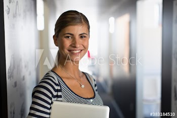 Portrait confident creative young businesswoman in corridor