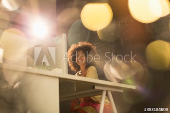 Portrait confident creative young businesswoman working at computer