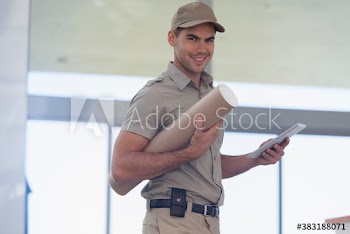 Portrait confident deliveryman with digital tablet and tube package