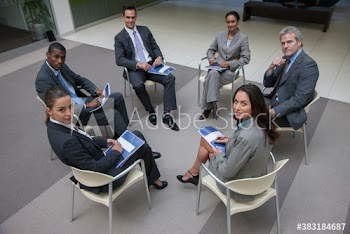 Portrait confident diverse corporate business people meeting in circle