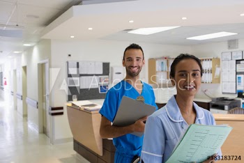 Portrait confident doctor and nurse in hospital corridor