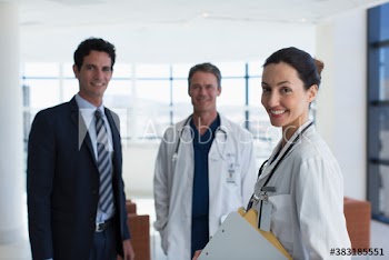 Portrait confident doctors and hospital administrator in lobby