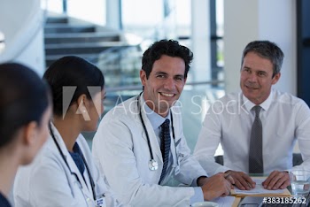 Portrait confident doctors talking in hospital meeting