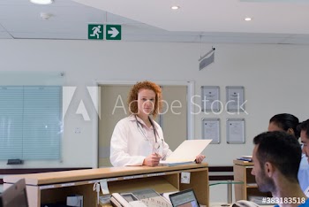 Portrait confident female doctor at nurses station in hospital