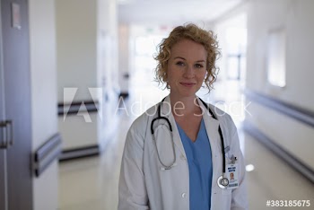 Portrait confident female doctor in hospital corridor