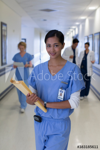 Portrait confident female nurse in hospital corridor