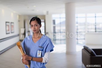 Portrait confident female nurse in hospital corridor
